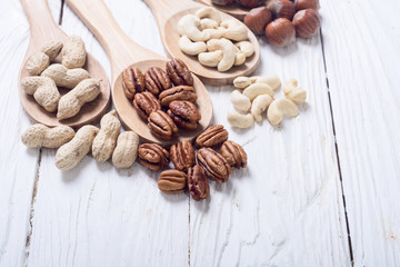 Mix of nuts in wooden spoon