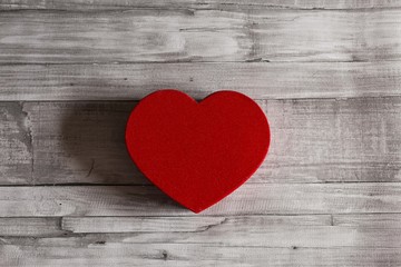 red heart over grey wood background, isolated. Valentines day concept