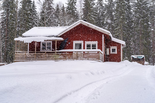 Little Red House In Forest With Snow