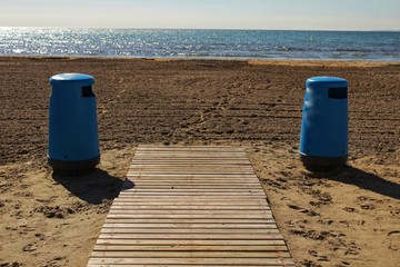 Wastebaskets and walkway to the beach