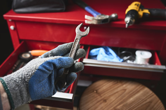 a mechanic holding a wrench