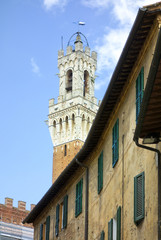 Fototapeta na wymiar Siena house and view of the Campanile, Torre del Mangia, 2017.