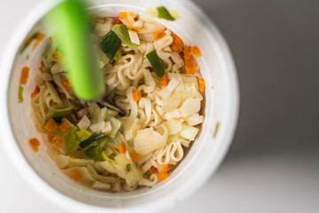Asian instant noodles in a white recipient, typical fried chinese noodles, asian noodles, with the supermarker recipient, ready-made food
