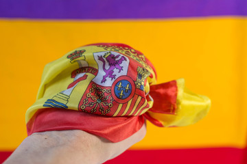 spanish flag surrounding a hand with the spanish republic flag on the background