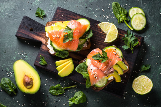 Open sandwich with salmon spinach and avocado.