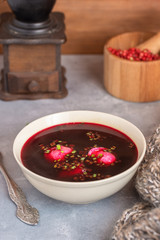Traditional polish clear red borscht with dumplings.