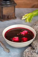 Traditional polish clear red borscht with dumplings.