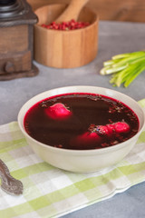 Traditional polish clear red borscht with dumplings.