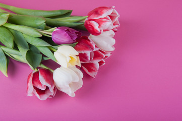 fresh spring bouquet laying on pink background