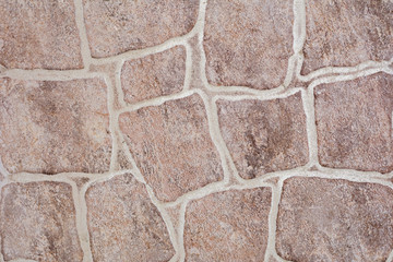 Beige stone wall texture with scratches and cracks