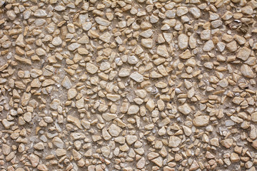 Beige stone wall texture with scratches and cracks