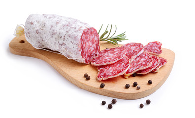 Sliced salami on cutting board with rosemary and peppercorns isolated on white background. - obrazy, fototapety, plakaty