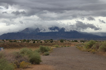New Mexico sandia mountain range seen by the black aroyo dam albuquerque on a rainy stormy day