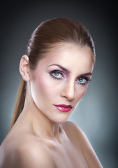 Professional make up - beautiful female art portrait with beautiful eyes. Elegance. Genuine natural woman in studio. Portrait of a attractive woman with red lips and creative make up 