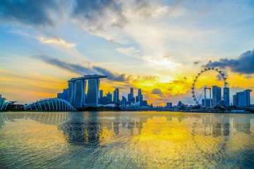 Tuinposter SINGAPORE CITY, SINGAPORE: Feb 2,2018: Singapore Skyline. Singapore`s business district, marina bay sand and the garden by the bay on sunrise © rueangrit