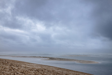 Panorama of the Pilat Dune (Dune du Pilat) during a cloudy afternoon with the Atlantic Ocean in background. Pilat, or Pyla Dune is the biggest sand dune in Europe, located in Arcachon Bay, Aquitaine