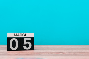 March 5th. Day 5 of march month, calendar on turquoise background. Spring time, empty space for text, mockup
