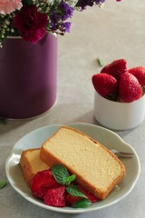 Sliced homemade butter pound cake served with strawberries, selective focus
