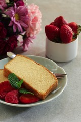 Sliced homemade butter pound cake served with strawberries, selective focus