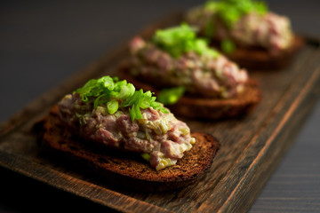 bruschetta, on slices of toasted baguette garnished with basil