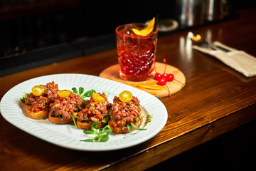bruschetta, on slices of toasted baguette garnished with basil