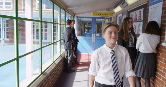 4K Popular & Confident School Kid Walking Through School Greeting Other Pupils