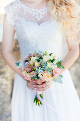 Bridal bouquet. A bouquet of flowers is kept in the hand by a bride at a wedding. Emotion of love is the tenderness