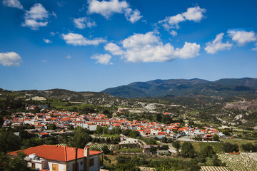 Fototapeta na wymiar Orange roofs. Panoramic view near of Kato Lefkara - is the most famous village in the Troodos Mountains. Limassol district, Cyprus, Mediterranean Sea. Mountain landscape and sunny day.