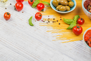 Ingredients for preparation pasta spaghetti - tomato, olive oil, spices, herbs, green olives, tomato sauce