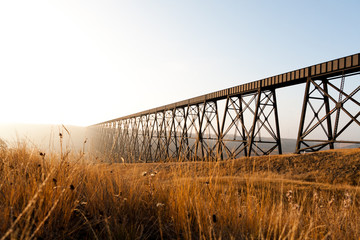 Steel train bridge on a prairie field