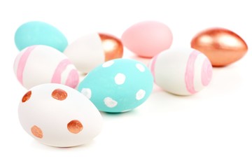 Easter border or background of turquoise, pink, white and rose gold eggs over white