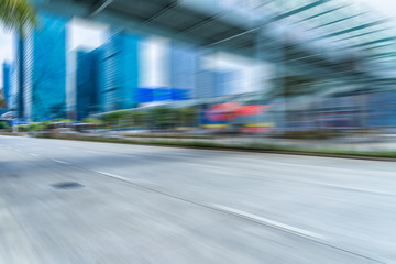 Fototapeta na wymiar blurred asphalt road front of modern buildings