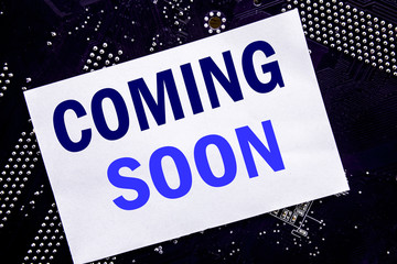 Handwritten text showing Coming Soon. Business concept for Message Future Written on sticky note,...