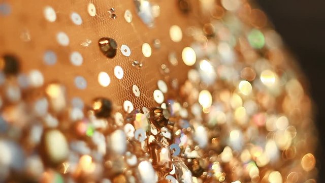 shining crystals and rhinestones on the dress while moving close-up