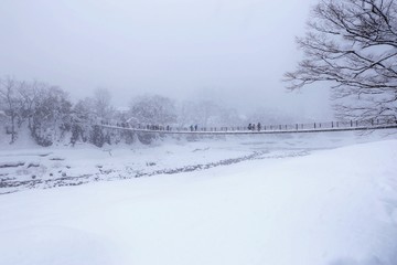 a suspension bridge in a heavy snow day