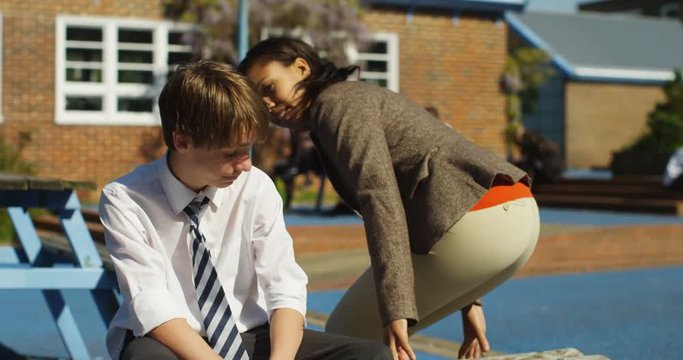 4k, A concerned teacher talking to a young boy teased at school. Slow motion