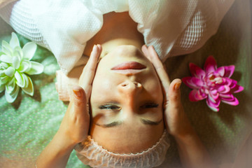 ultrasonic face cleaning Young pretty woman receiving treatments in beauty salons. Young beautiful dark-haired woman in the office beautician lying on the couch. Ultrasonic cleaning procedure.