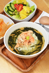 Japanese cuisine,  rice in green tea with salmon  and seaweed 