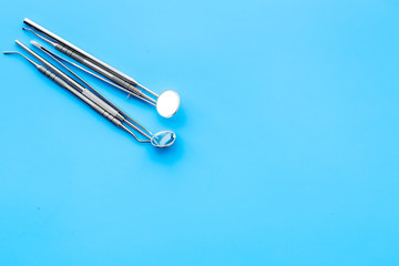 Fototapeta premium Dentist tools. Teethcare, dental health concept. Blue background top view copy space