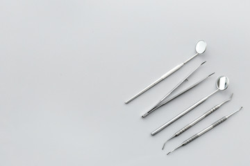 Dentist tools. Teethcare, dental health concept. Grey background top view copy space