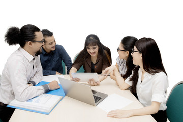 Business people using a tablet on studio