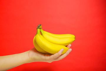 banana and hand.  バナナを手にもつ　赤色背景