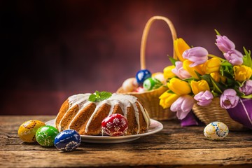 Easter Cake. Traditional ring marble cake withe easter decotation. Easter eggs and spring tulips.
