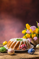 Easter Cake. Traditional ring marble cake withe easter decotation. Easter eggs and spring tulips.
