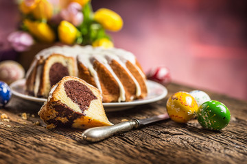 Easter Cake. Traditional ring marble cake withe easter decotation. Easter eggs and spring tulips.