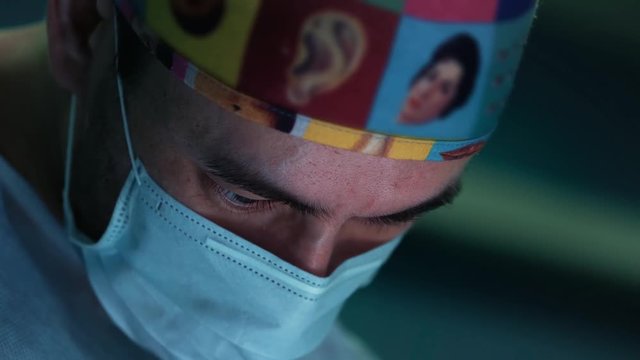 Closeup shot of male surgeon performing an operation. portrait of a surgeon at work. Saves life in intensive care