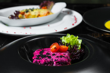 Set dinner of two courses. Chef's specialty presented in restaurant on served table. Clouse up.