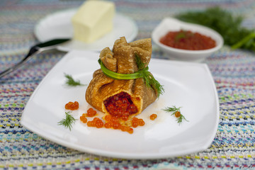 Russian pancakes, traditional for Russian pancake week with red cavier and honey