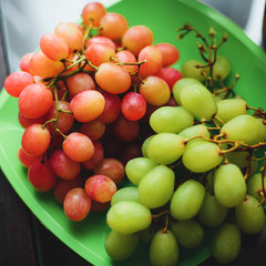 bunches of red and green grapes on a plate for healthy vitamin nutrition