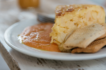 Close up of plate of spanish omelette with salmorejo, a typical